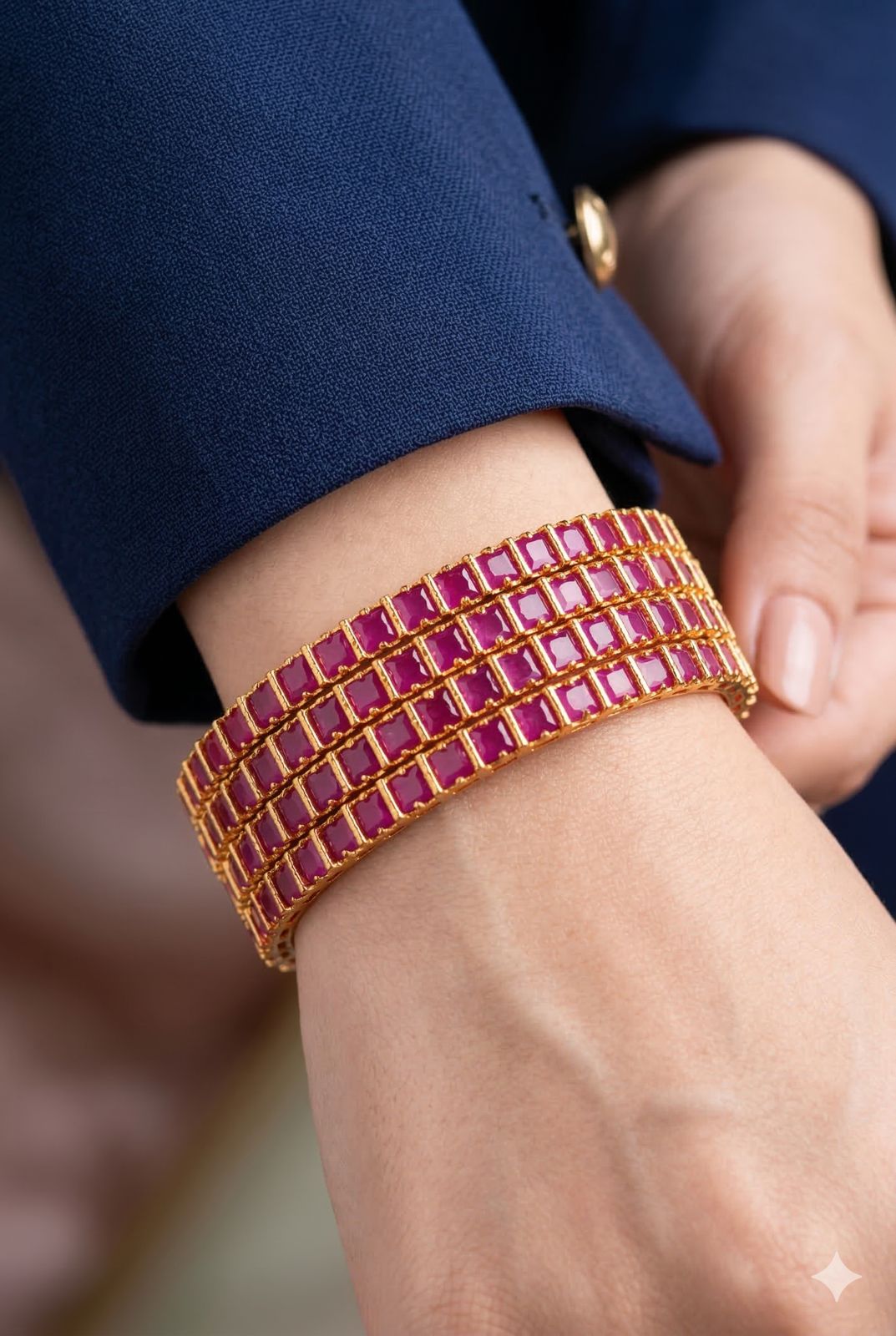 Close-up of a hand wearing a pink beaded bracelet on a blurred background